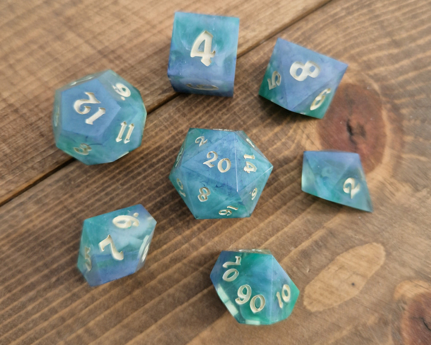 Hand crafted resin dice in green, blue and cream with bone coloured numbers