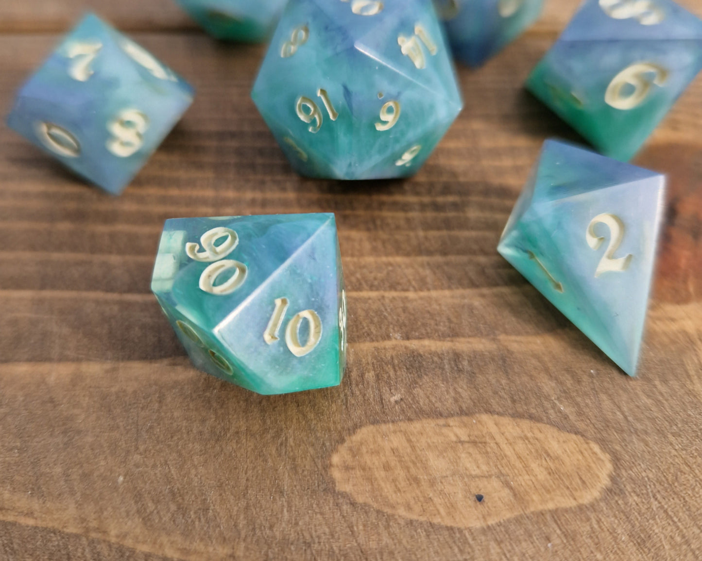 Hand crafted resin dice in green, blue and cream with bone coloured numbers
