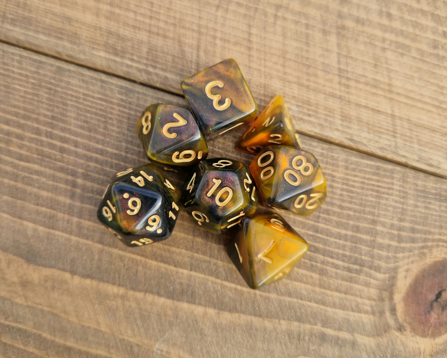 plastic polyhedral dice set in rich orange and black with shimmer
