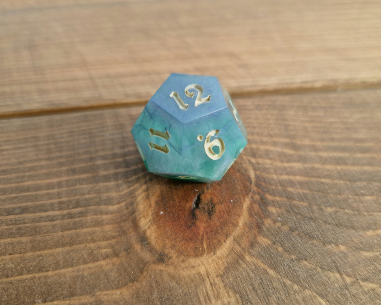 Hand crafted resin dice in green, blue and cream with bone coloured numbers