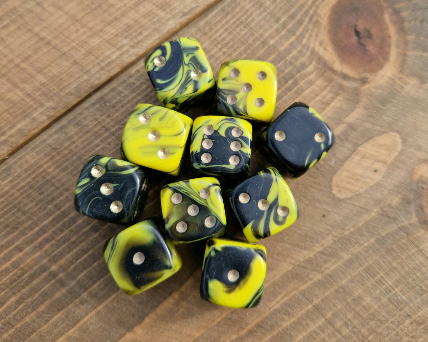 yellow and black d6 spot dice with gold dots