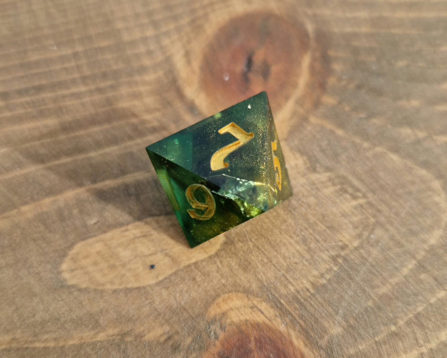 Green and gold resin dice