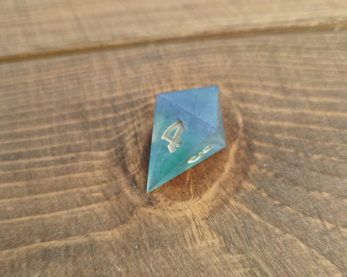 Hand crafted resin dice in green, blue and cream with bone coloured numbers