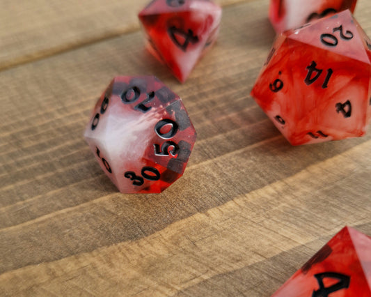 Red and white sharp resin dice with black numbers