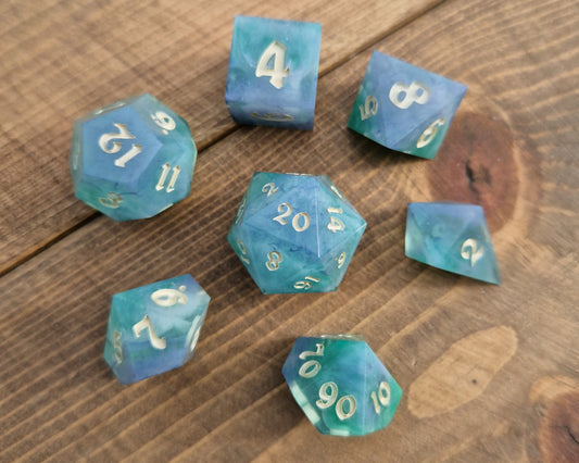 Hand crafted resin dice in green, blue and cream with bone coloured numbers