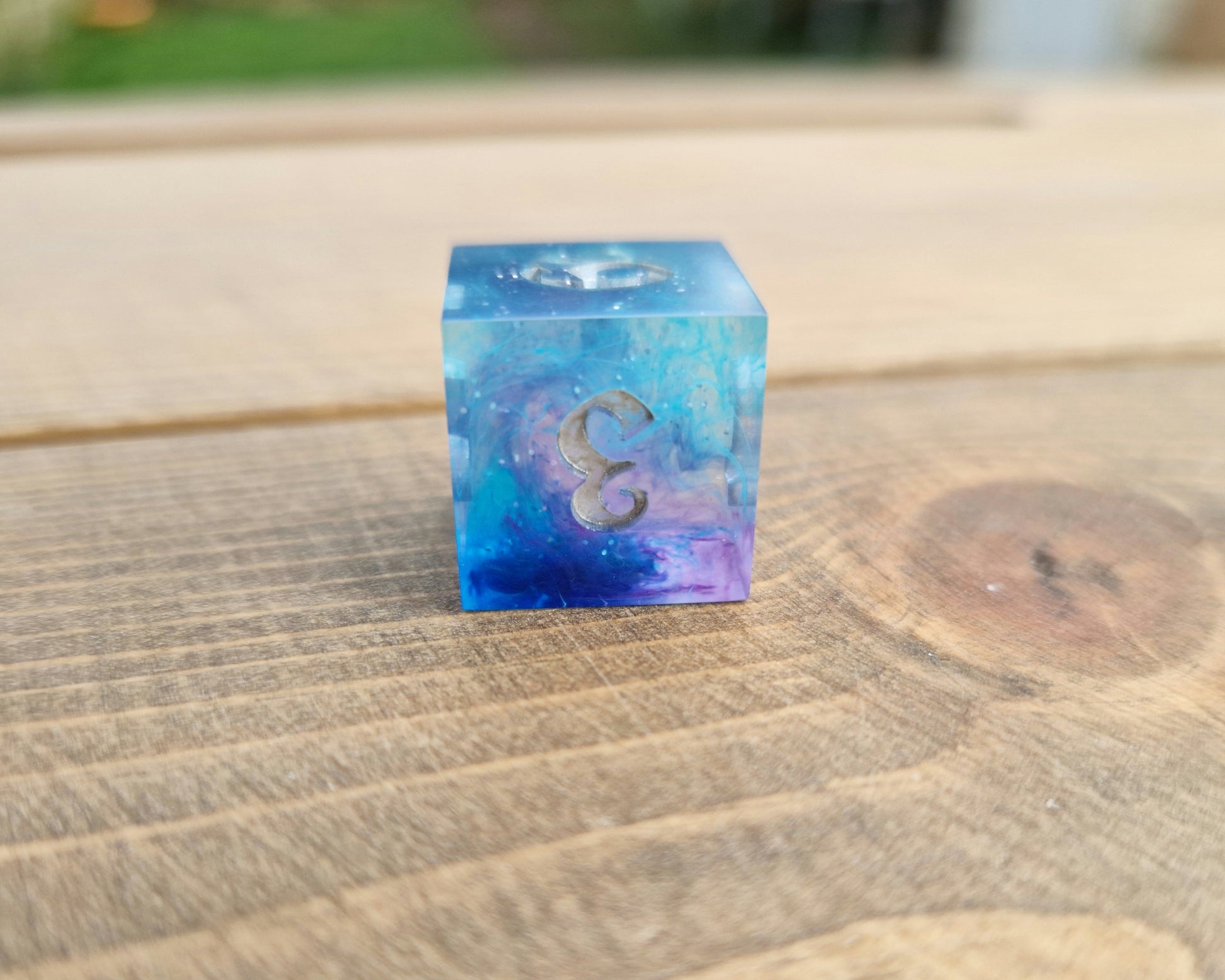 Blue and purple resin dice with silver numbers