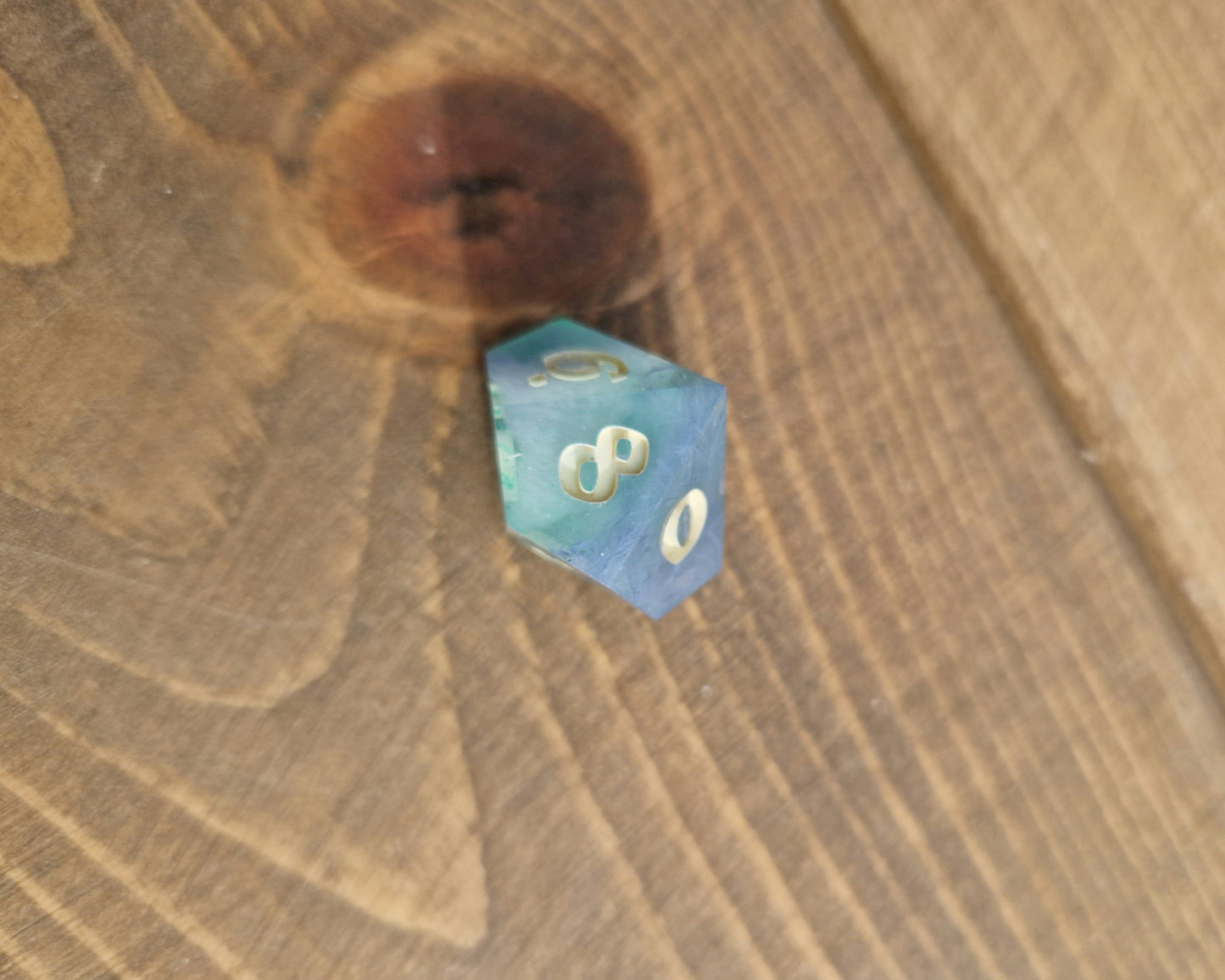 Hand crafted resin dice in green, blue and cream with bone coloured numbers
