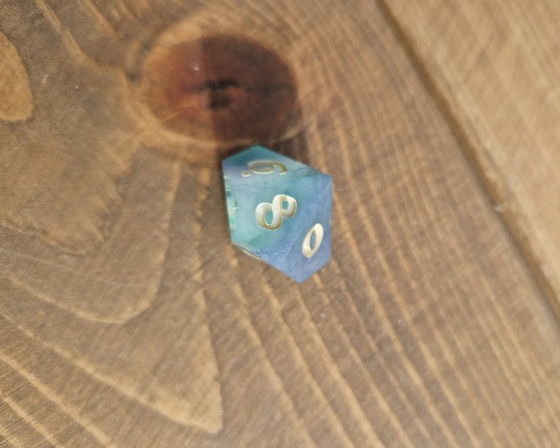 Hand crafted resin dice in green, blue and cream with bone coloured numbers