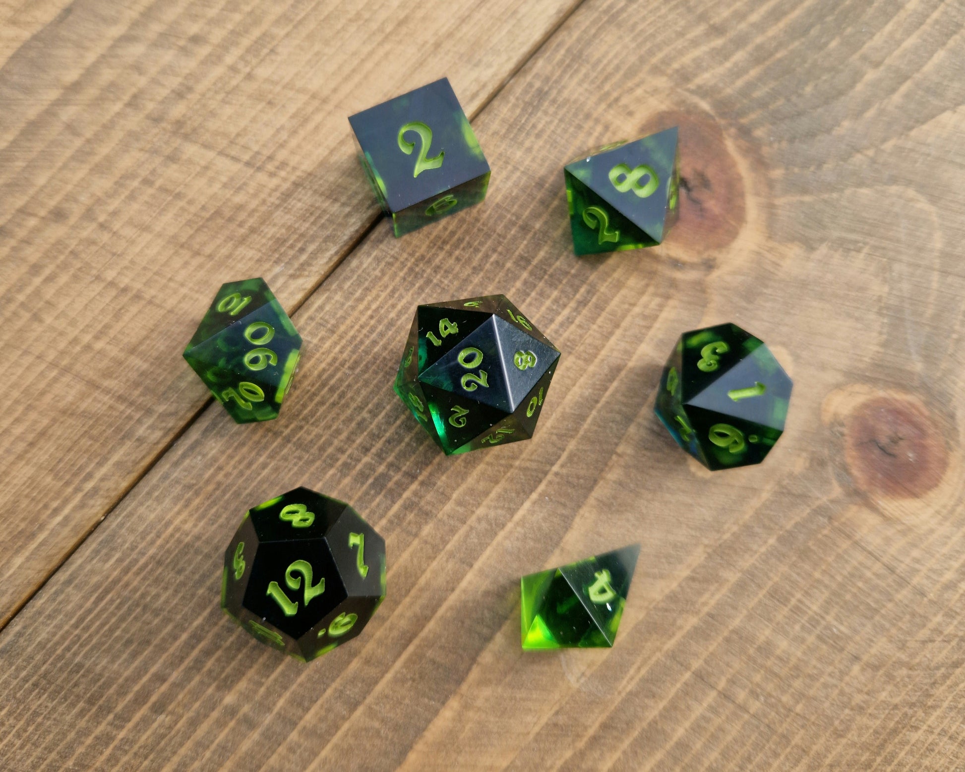 Dark green resin dice with bright green numbers