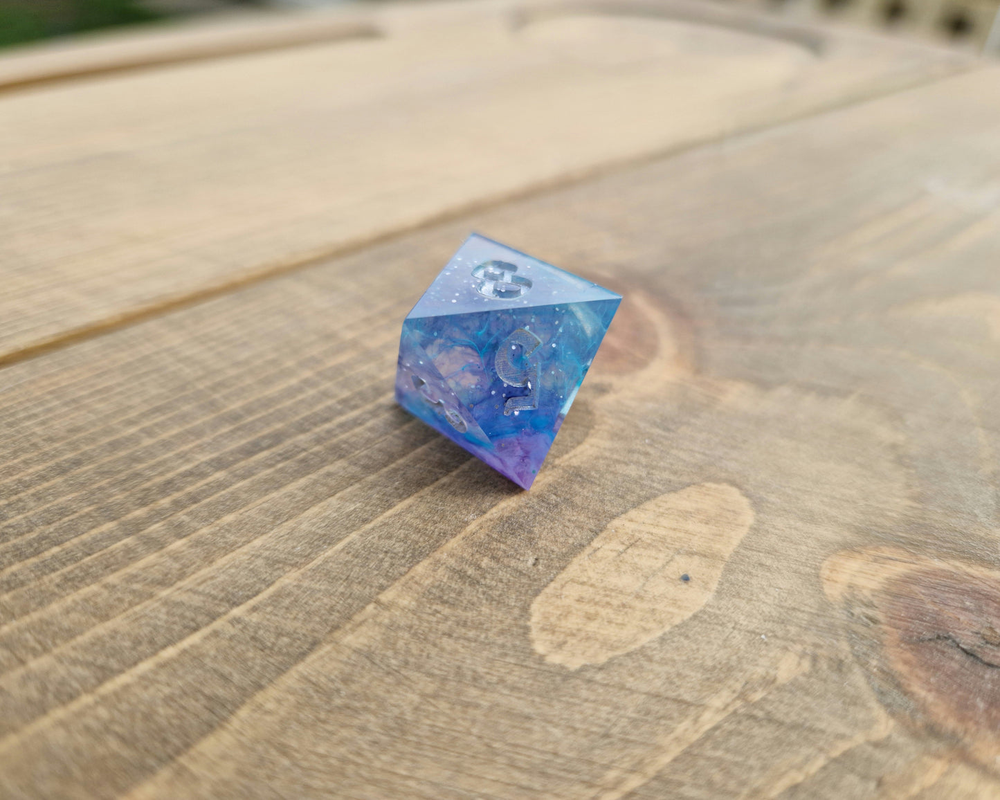 Blue and purple resin dice with silver numbers