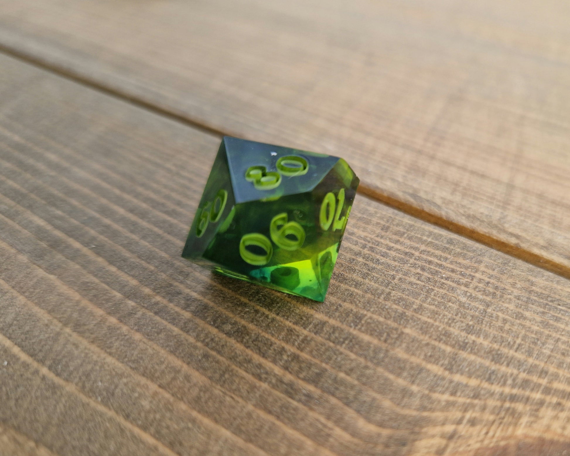 Dark green resin dice with bright green numbers