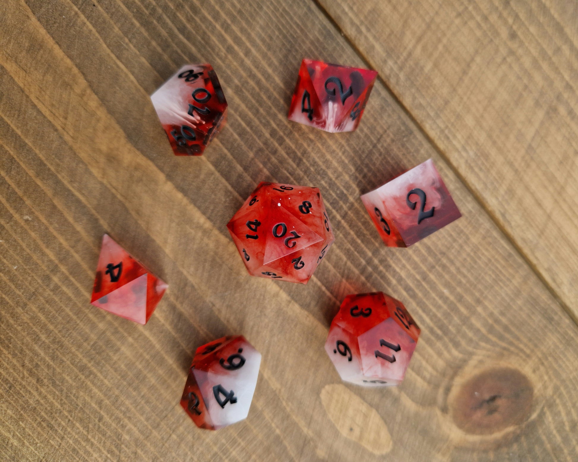 Red and white sharp resin dice with black numbers