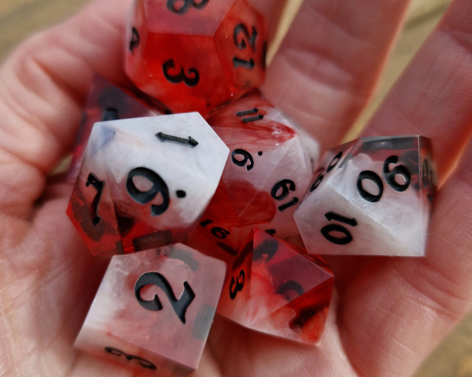 Red and white sharp resin dice with black numbers