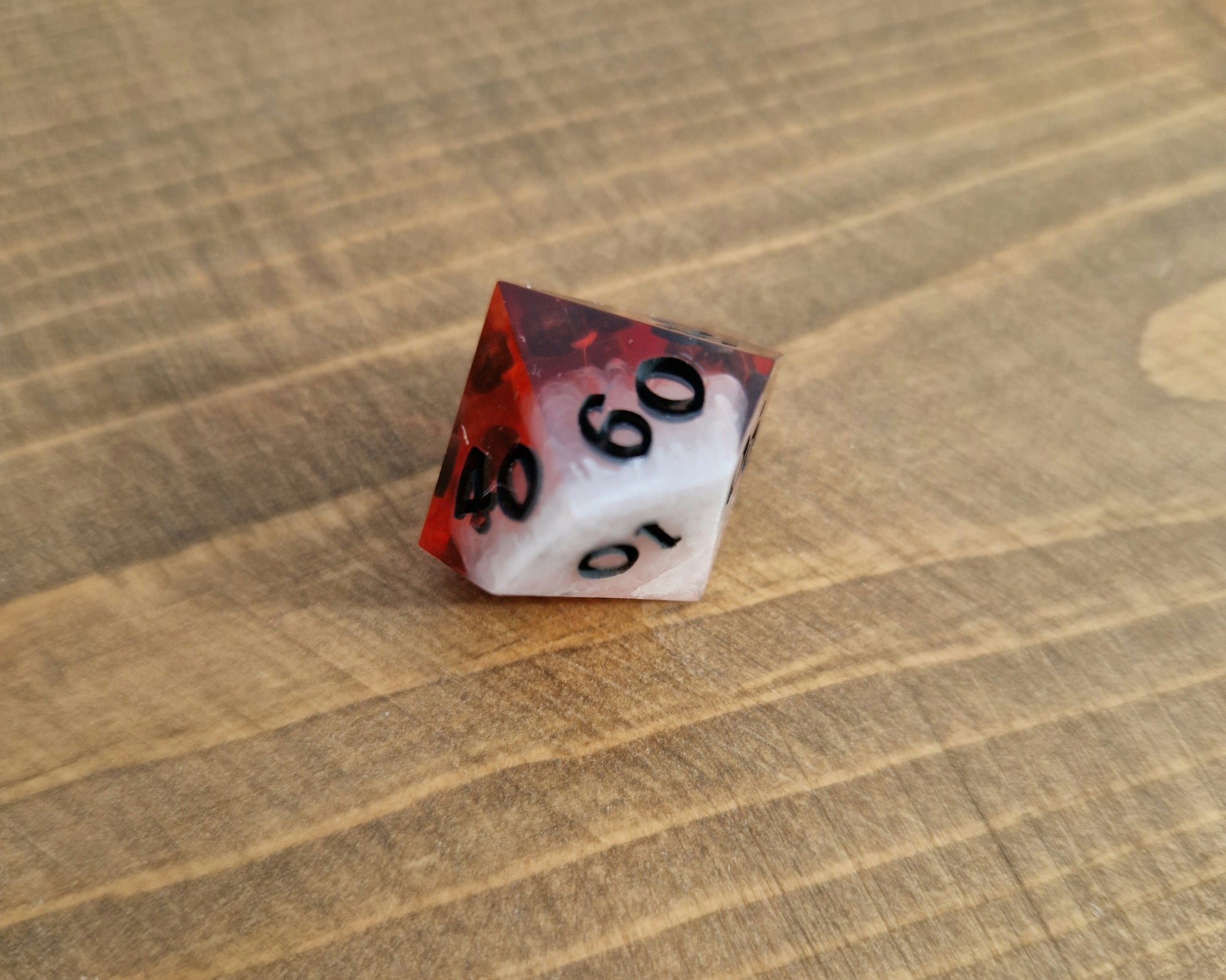 Red and white sharp resin dice with black numbers