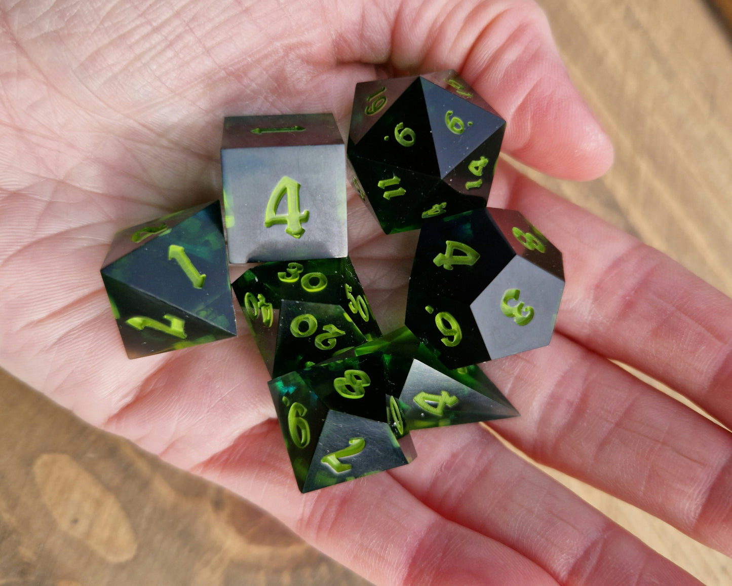Dark green resin dice with bright green numbers
