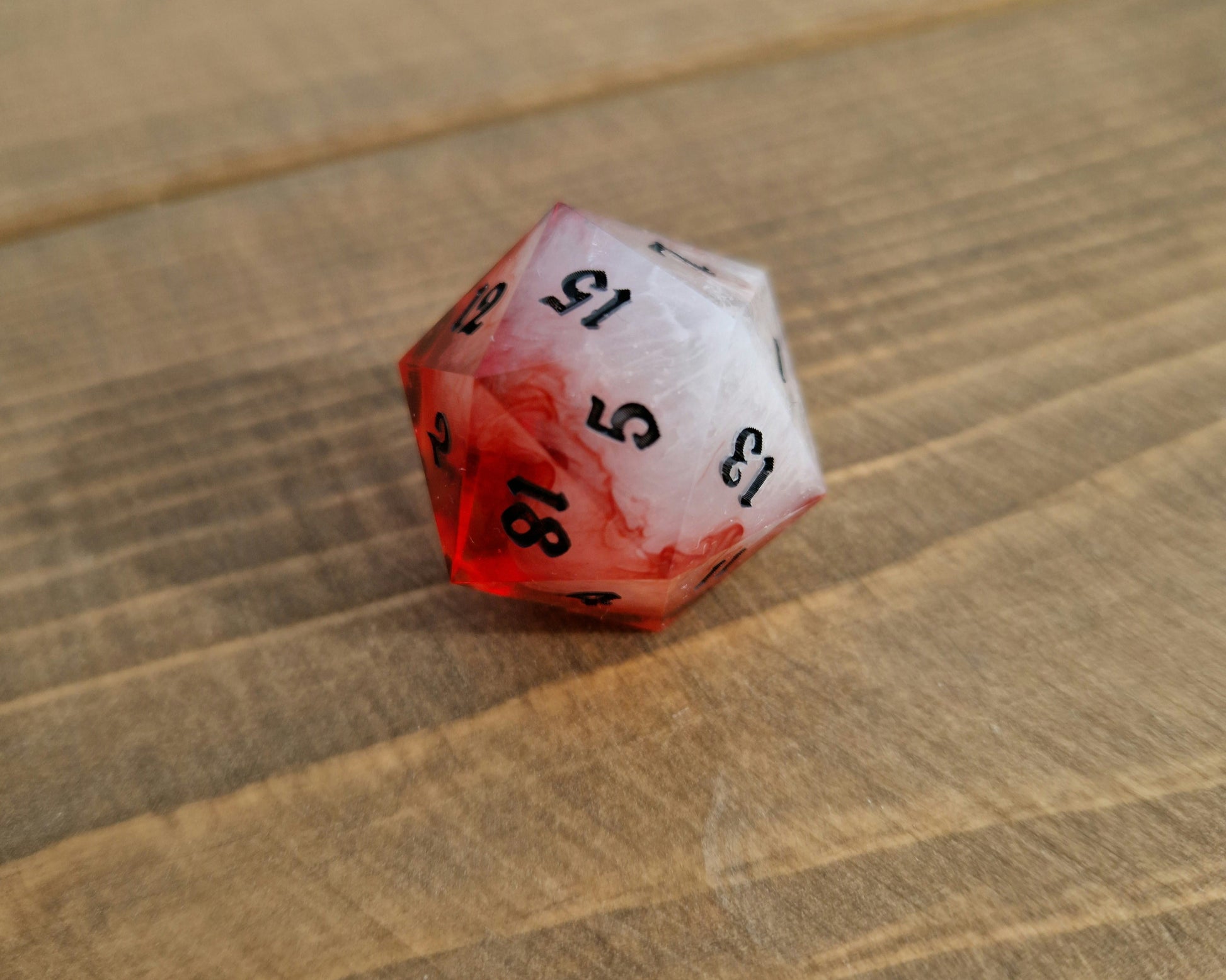 Red and white sharp resin dice with black numbers