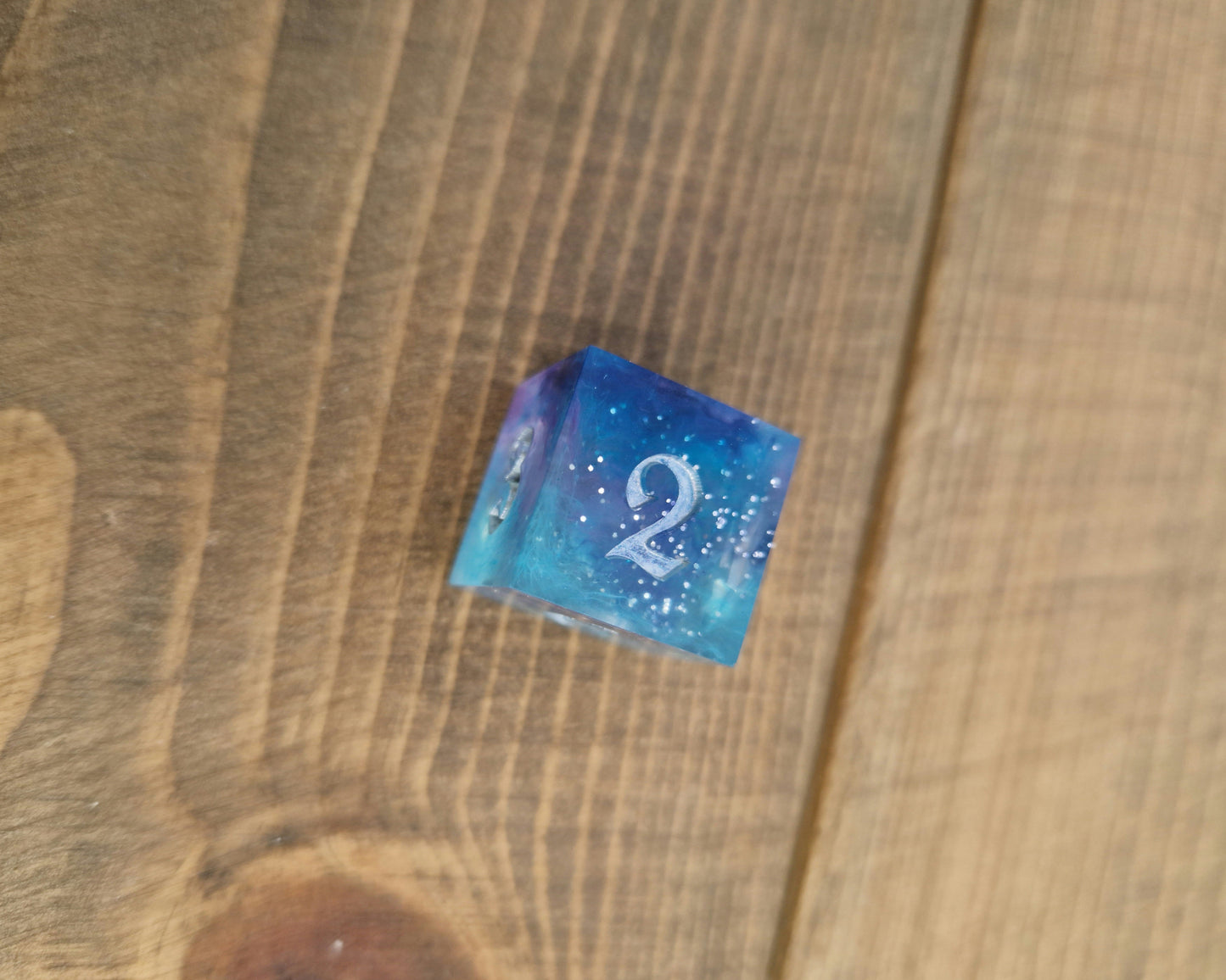 Blue and purple resin dice with silver numbers