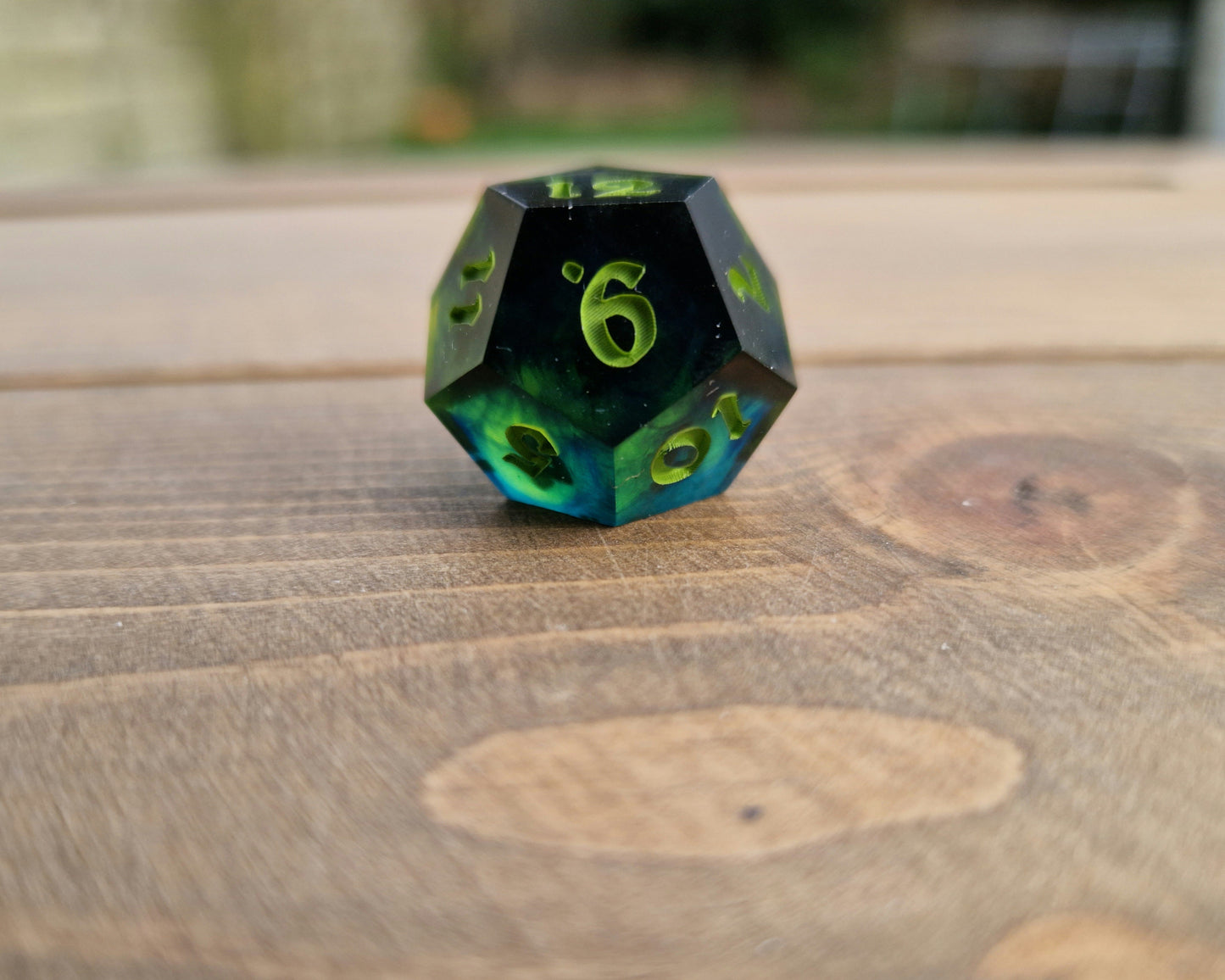 Dark green resin dice with bright green numbers