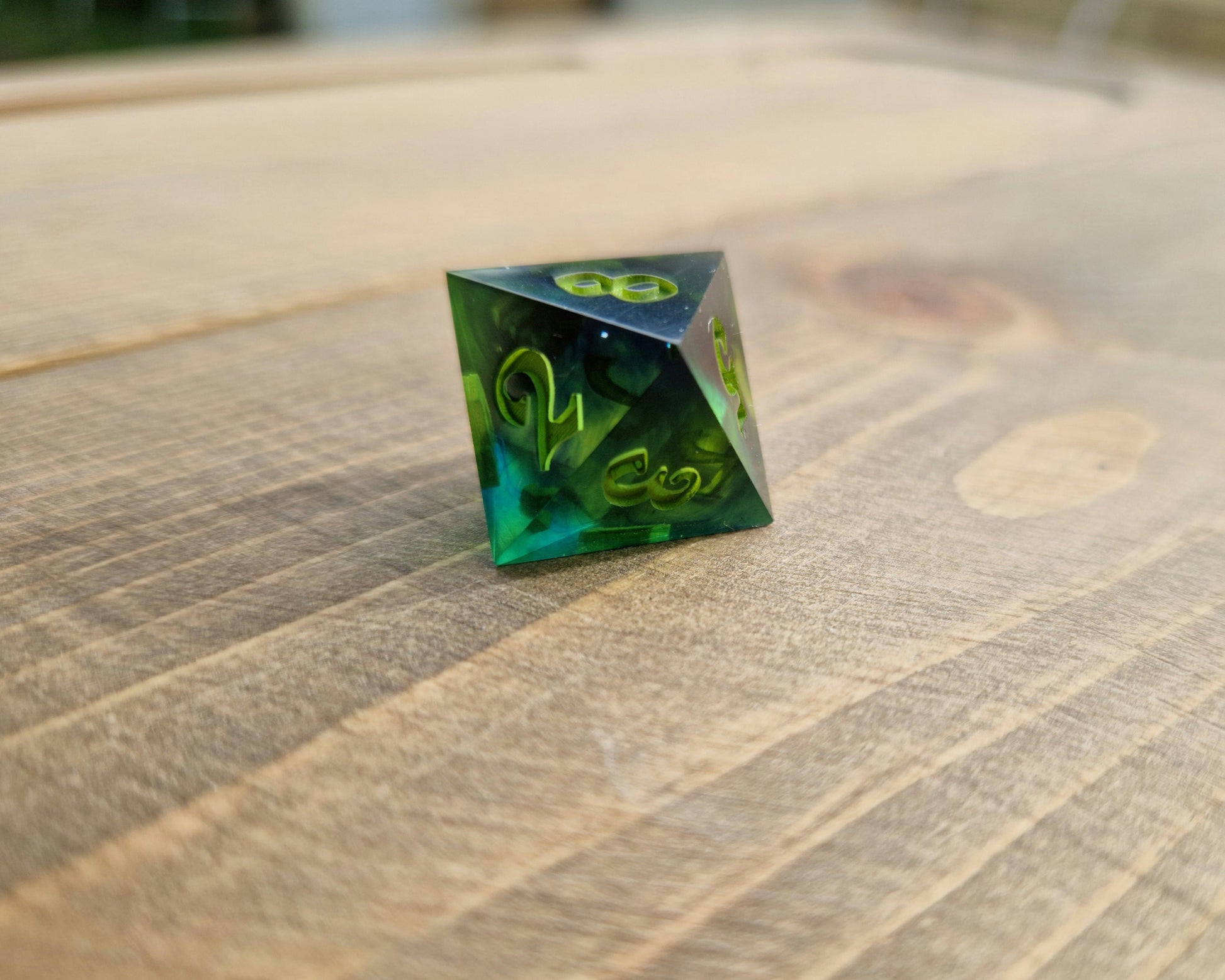 Dark green resin dice with bright green numbers