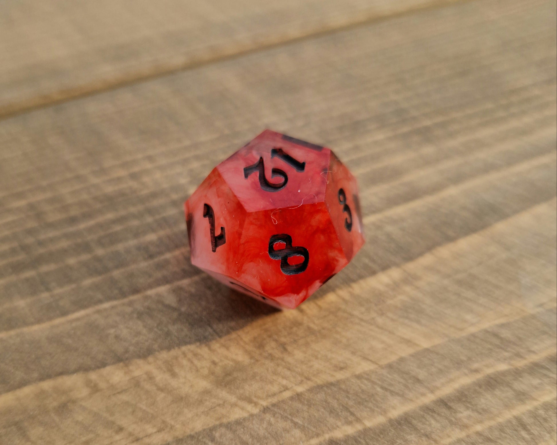 Red and white sharp resin dice with black numbers