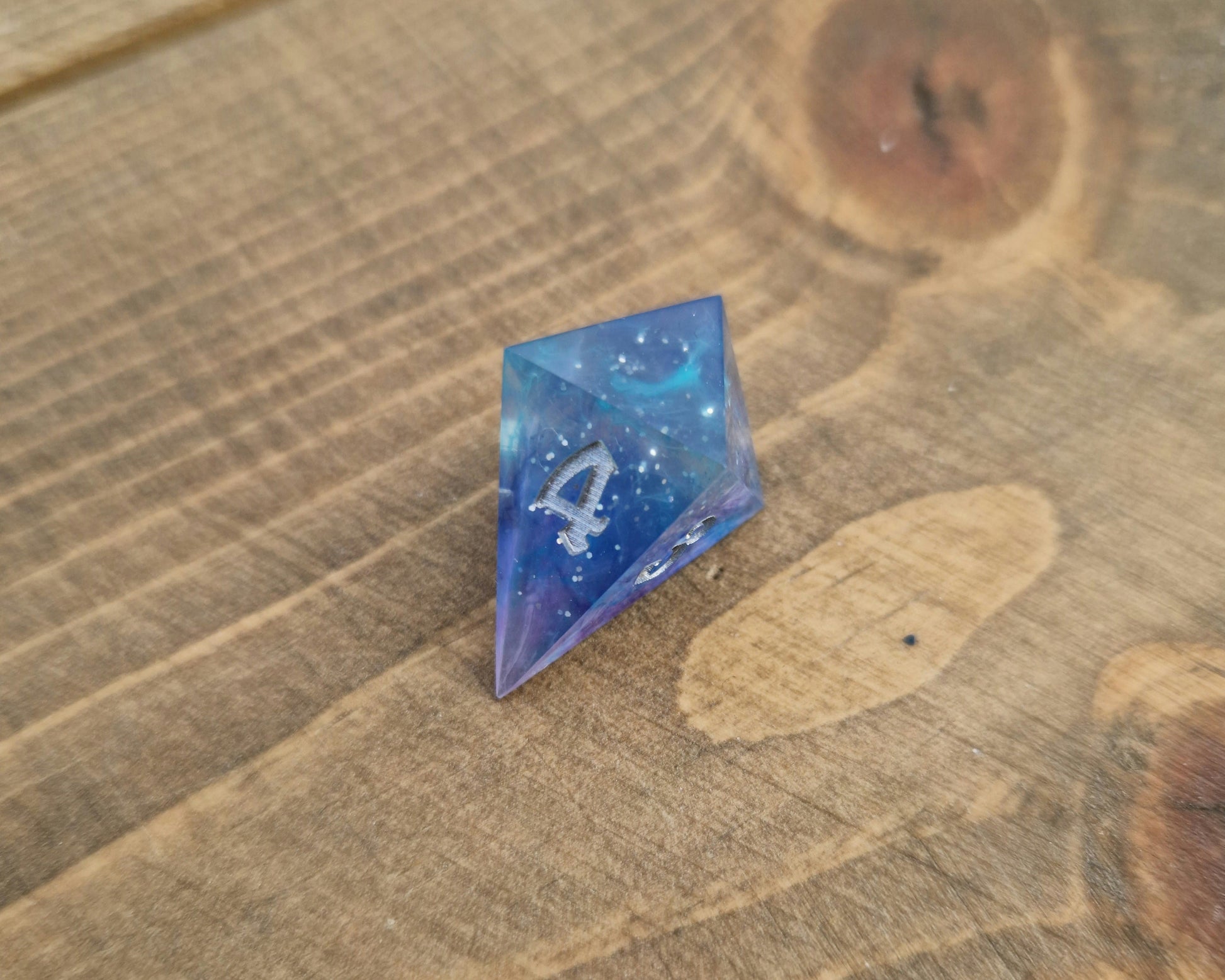 Blue and purple resin dice with silver numbers