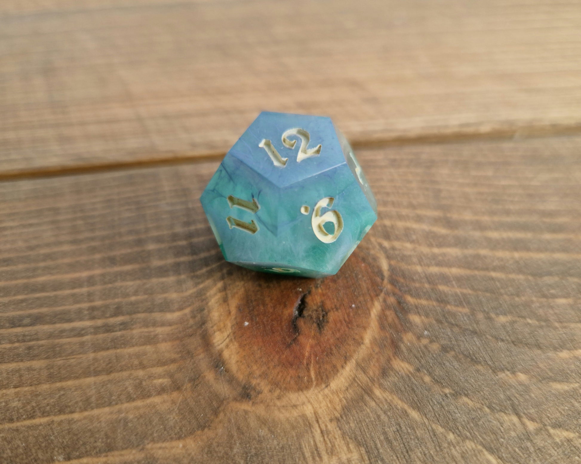 Hand crafted resin dice in green, blue and cream with bone coloured numbers