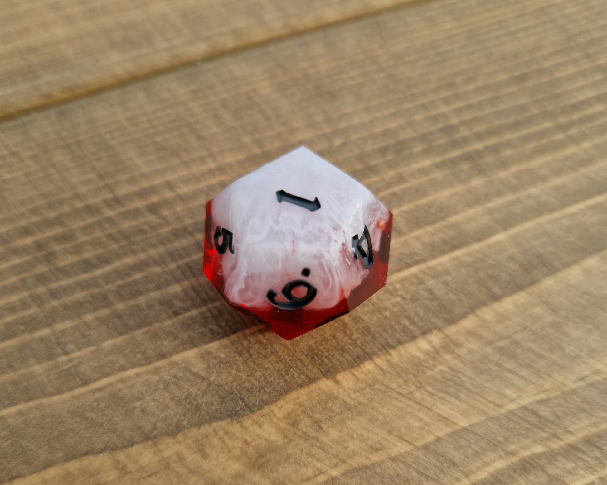 Red and white sharp resin dice with black numbers