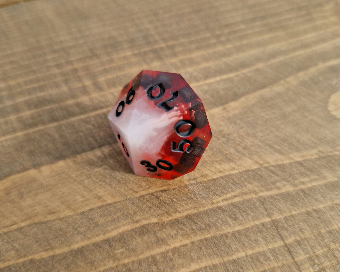 Red and white sharp resin dice with black numbers