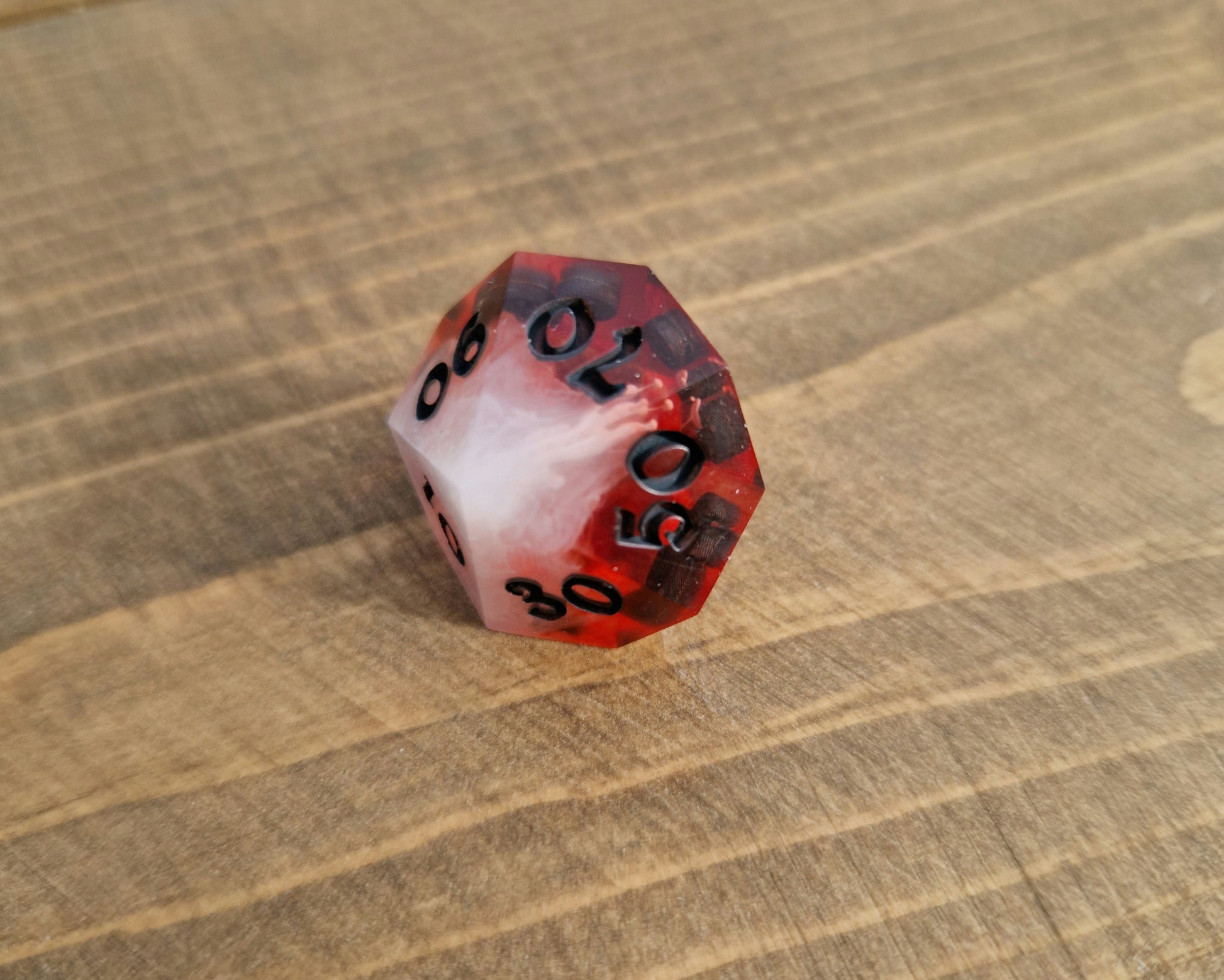Red and white sharp resin dice with black numbers