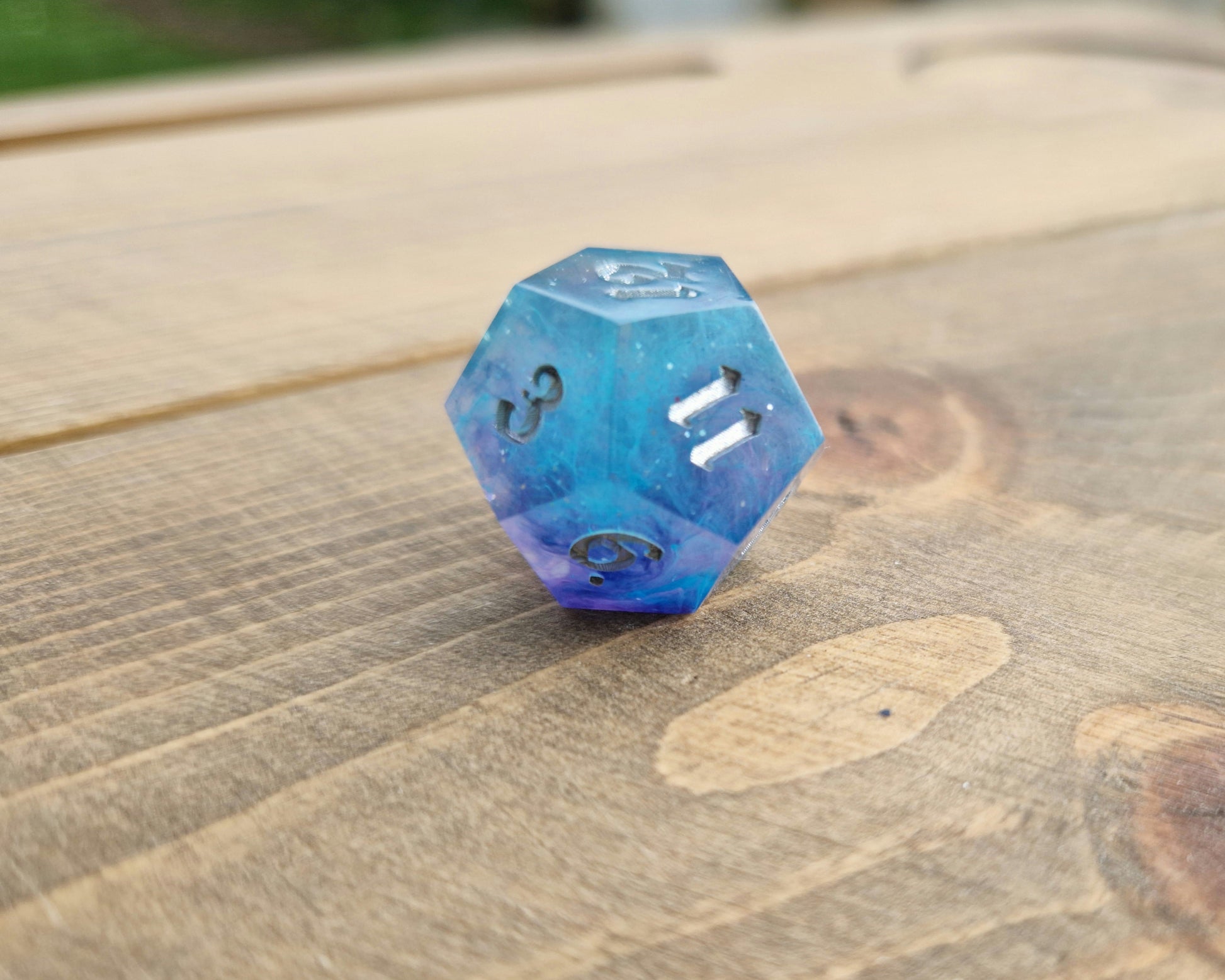 Blue and purple resin dice with silver numbers
