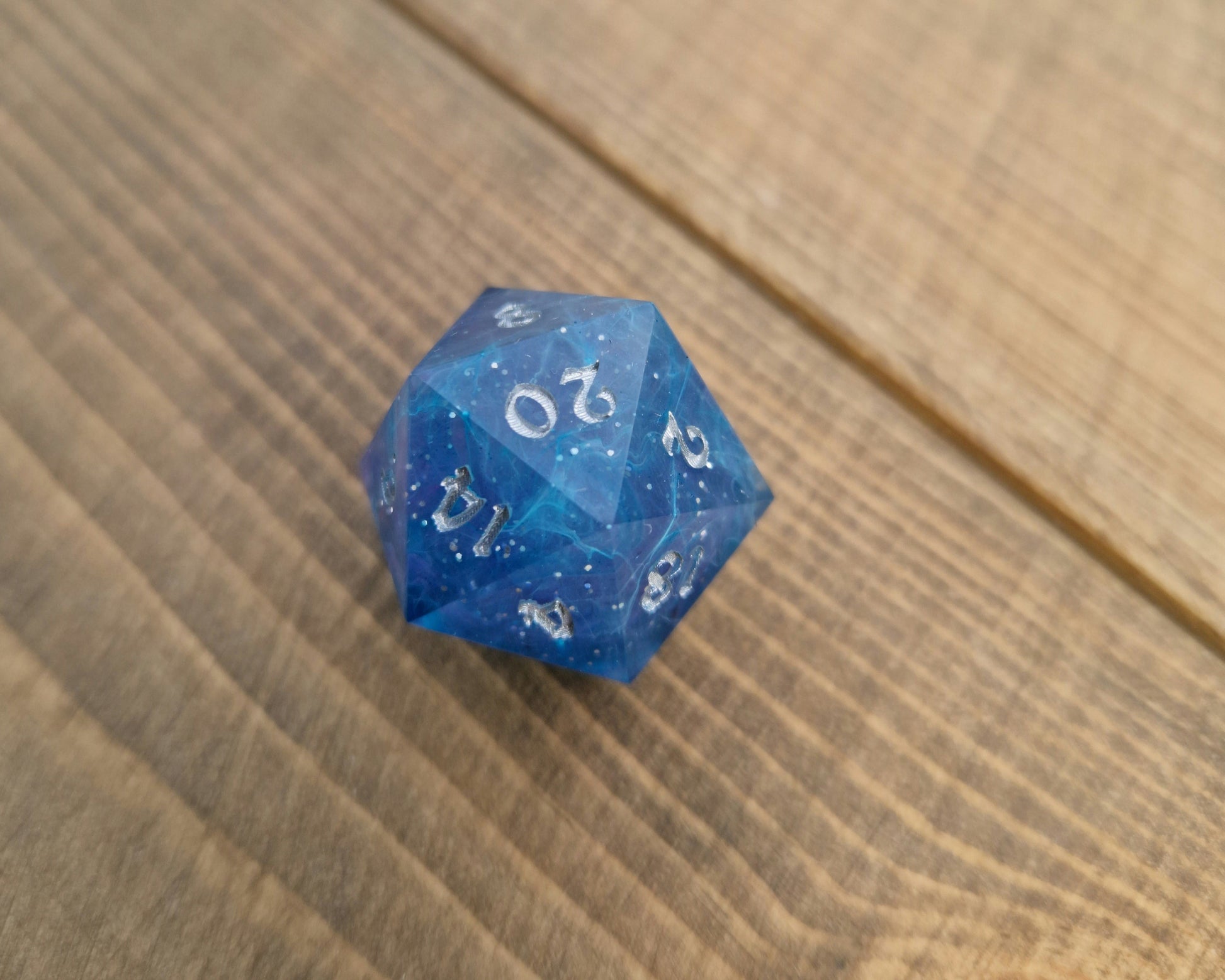 Blue and purple resin dice with silver numbers