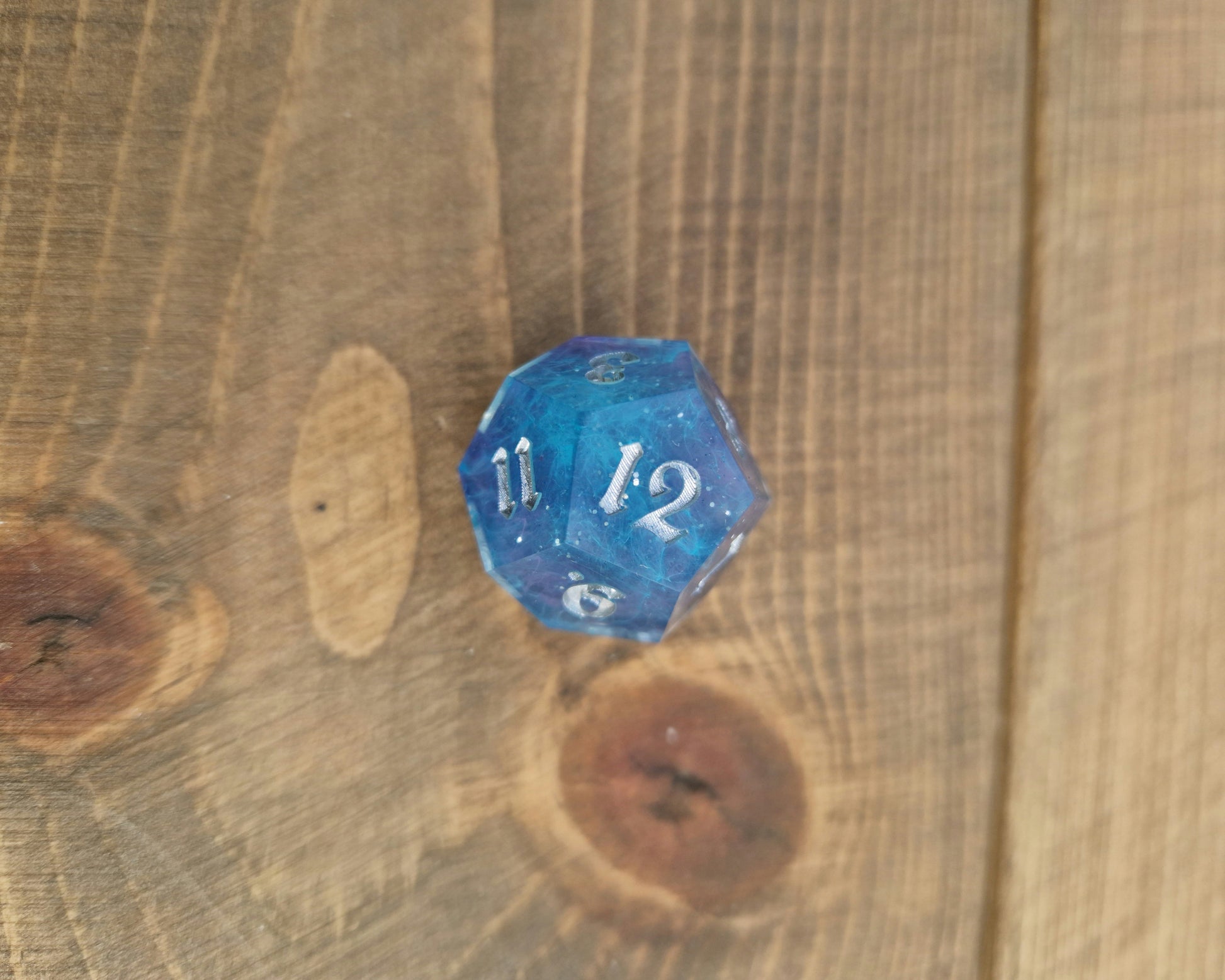 Blue and purple resin dice with silver numbers