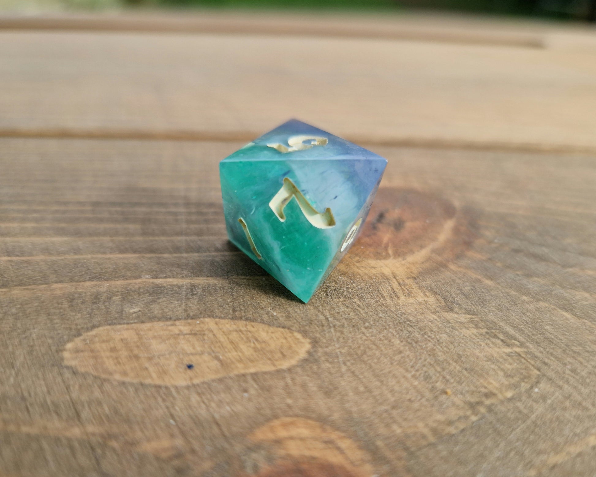 Hand crafted resin dice in green, blue and cream with bone coloured numbers