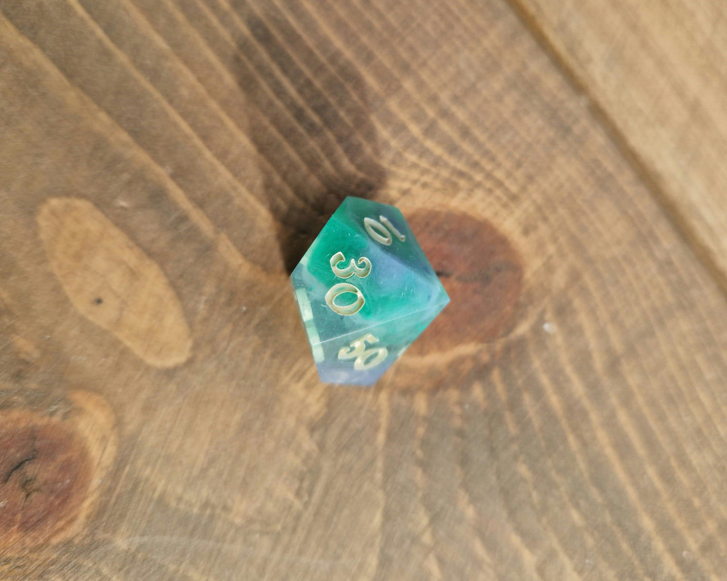 Hand crafted resin dice in green, blue and cream with bone coloured numbers