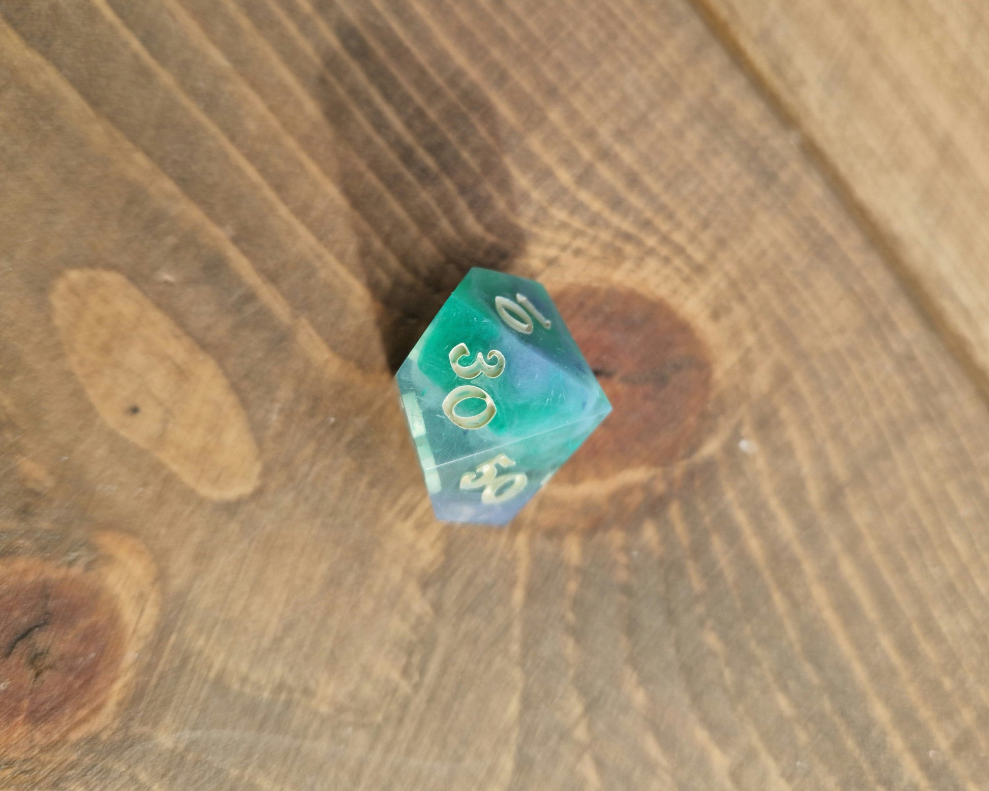 Hand crafted resin dice in green, blue and cream with bone coloured numbers
