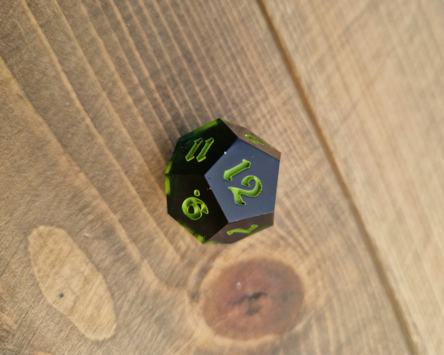 Dark green resin dice with bright green numbers