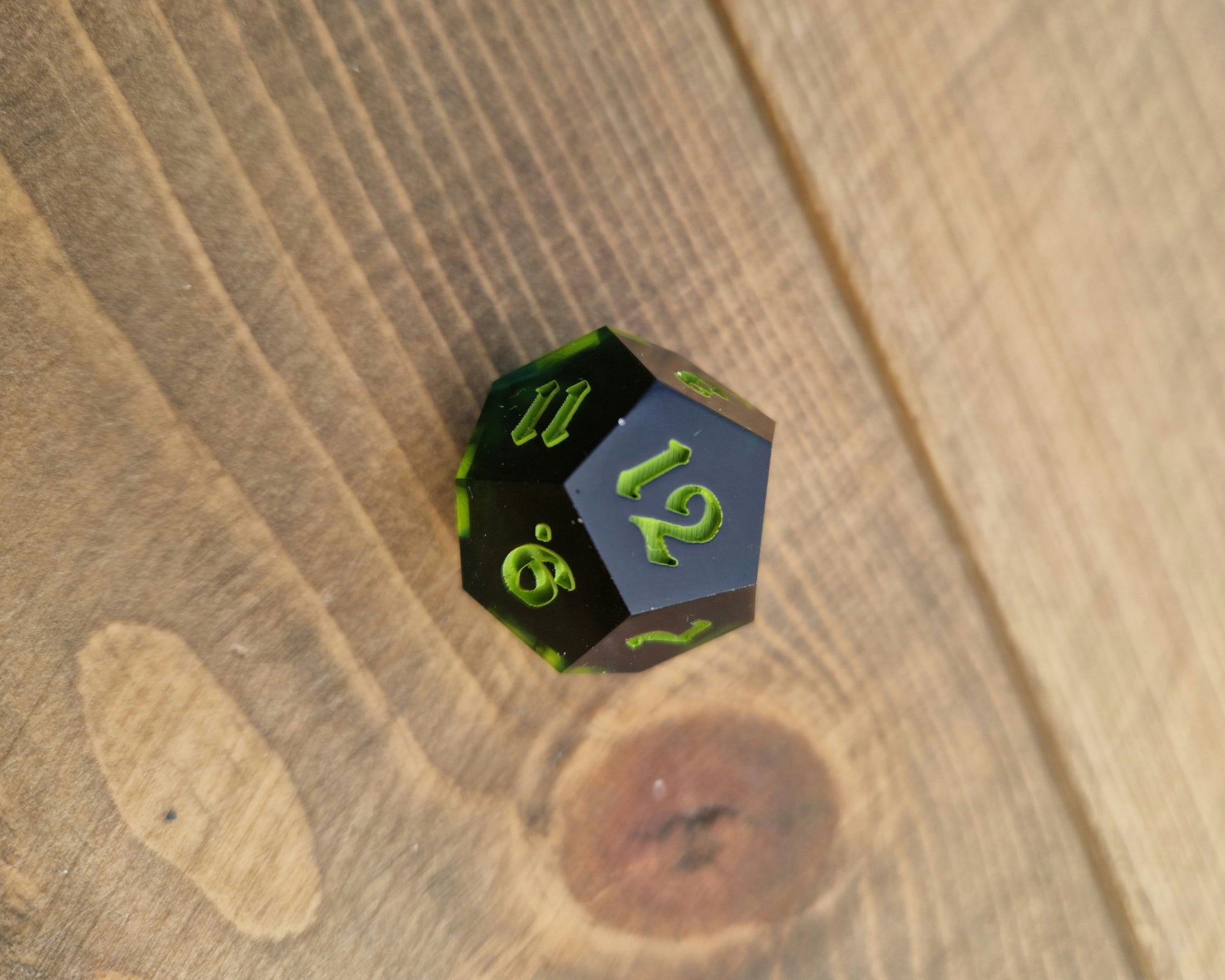 Dark green resin dice with bright green numbers
