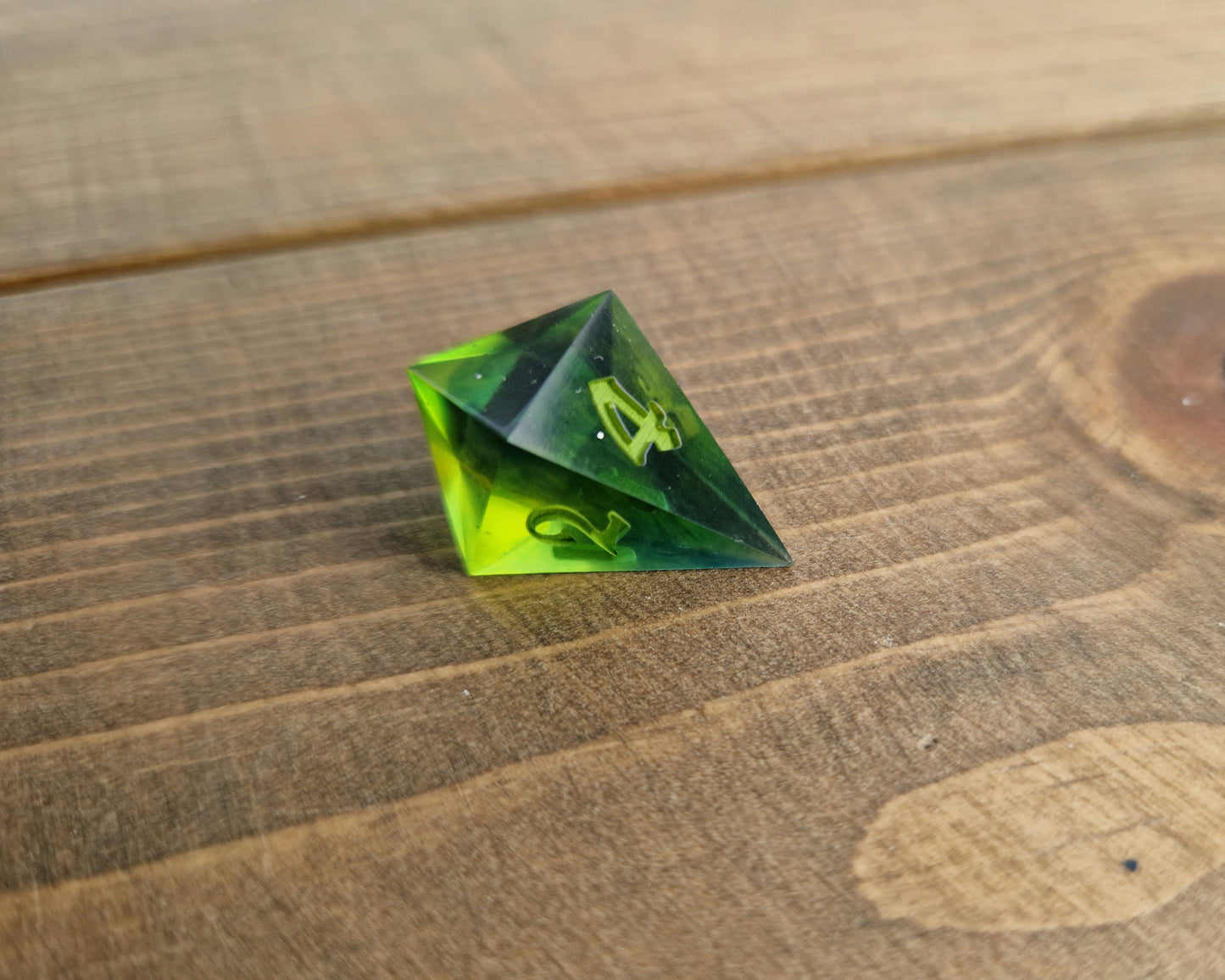 Dark green resin dice with bright green numbers