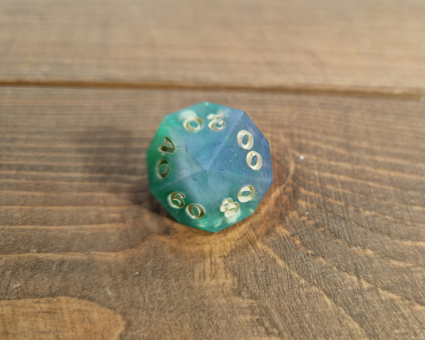 Hand crafted resin dice in green, blue and cream with bone coloured numbers