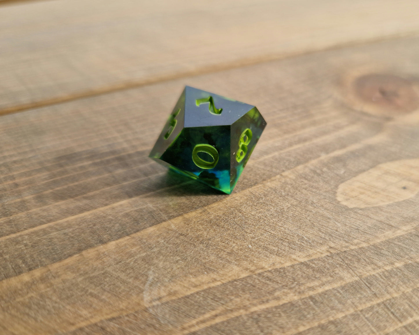 Dark green resin dice with bright green numbers