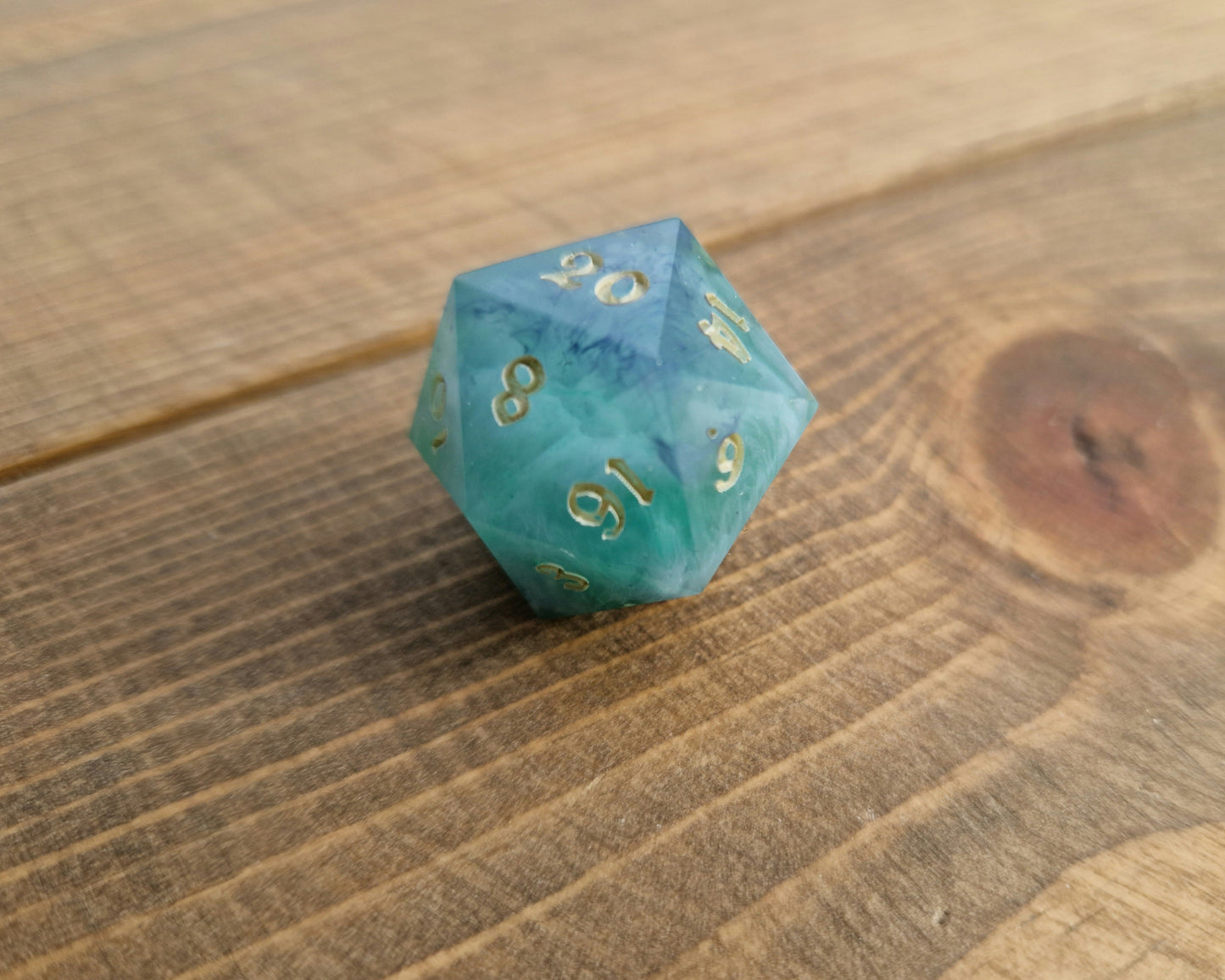 Hand crafted resin dice in green, blue and cream with bone coloured numbers
