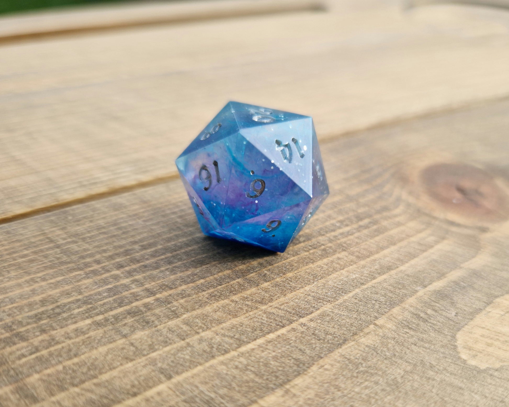 Blue and purple resin dice with silver numbers