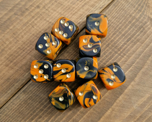 orange and black marble d6 spot dice with gold dots