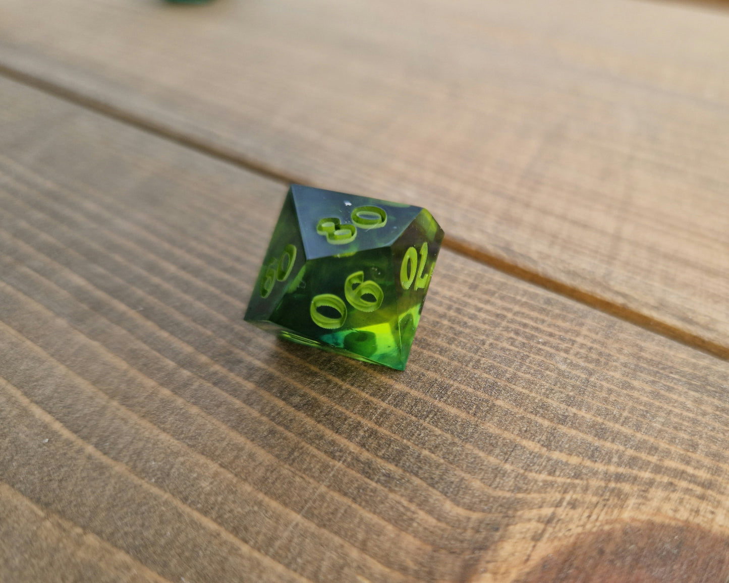 Dark green resin dice with bright green numbers