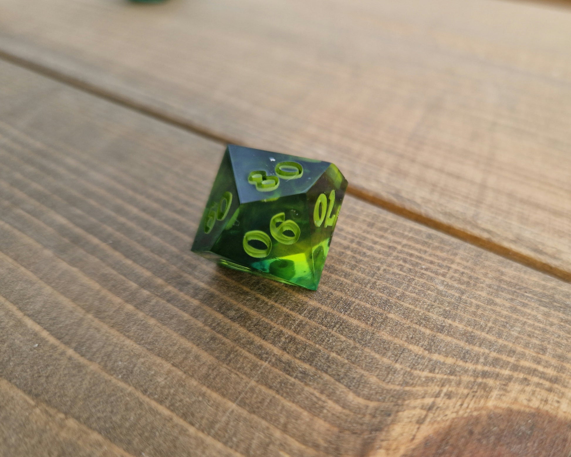 Dark green resin dice with bright green numbers