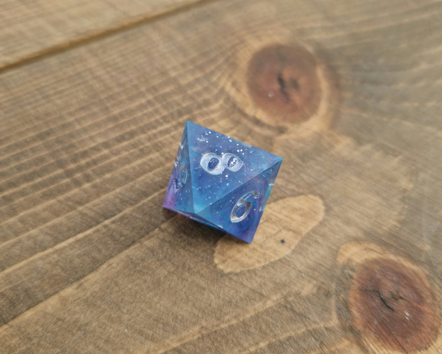 Blue and purple resin dice with silver numbers