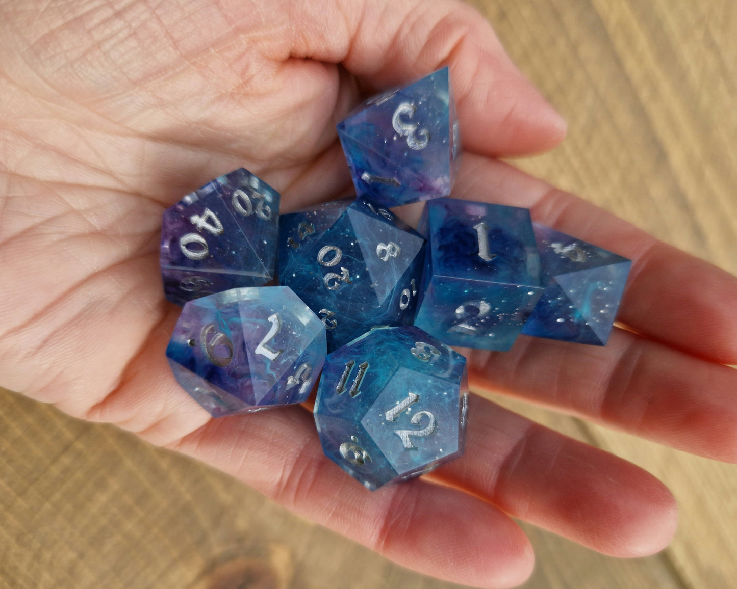 Blue and purple resin dice with silver numbers