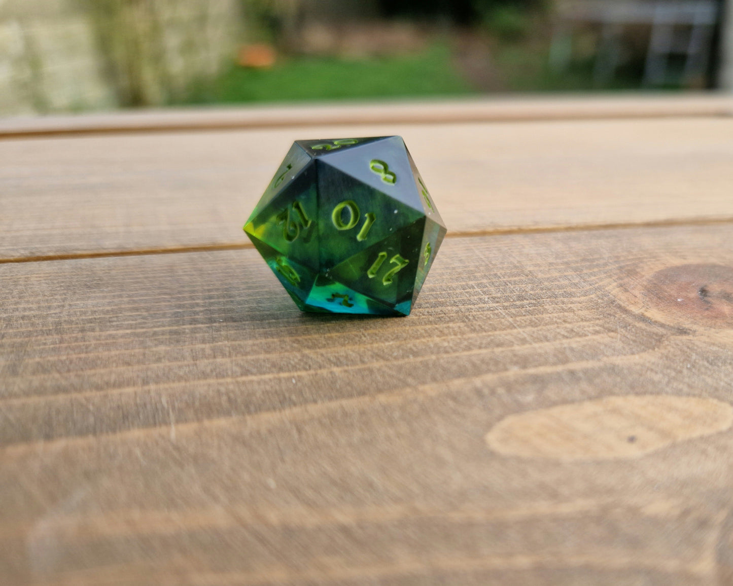 Dark green resin dice with bright green numbers